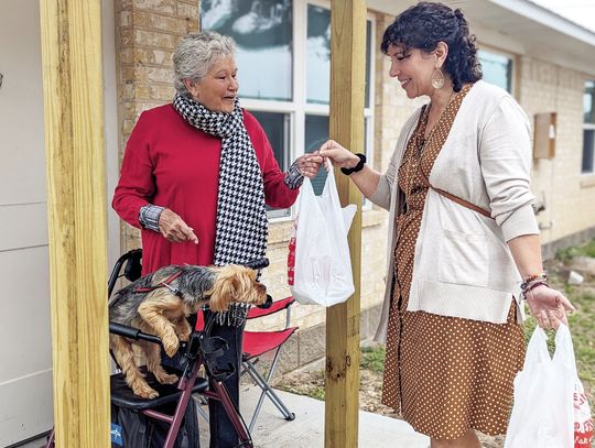 Regional Director of Philanthropy and Public Relations Lianna McNeil delivers a meal to a resident in Oak Bluff. Citizen | Trenton Whiting