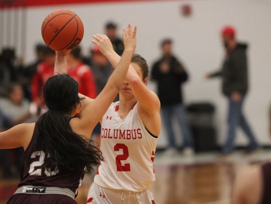 Sage Thomas passing the ball off to a teammate with a defender in her face. Citizen | Trent Whiting