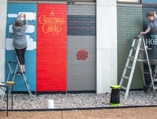 Local muralists finish book spines decorating Nesbitt