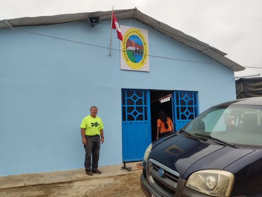 Pastor Alan Kethan stands in front of the completed church front with the church’s new sign. Courtesy photo