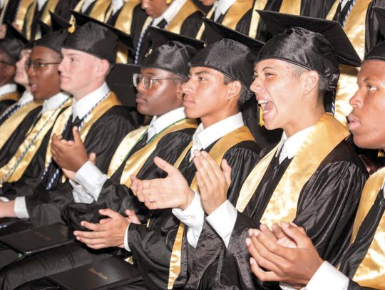 TCA graduates cross the stage in victory gold