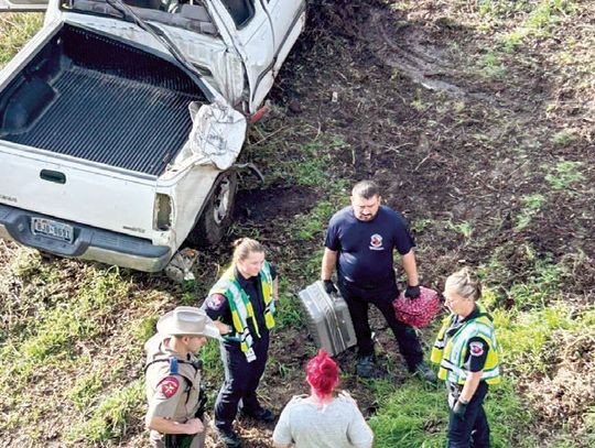 Truck leaves roadway, ends up by riverbank