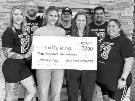 TURTLE WING RECEIVES CHECK FROM ANYTIME FITNESS