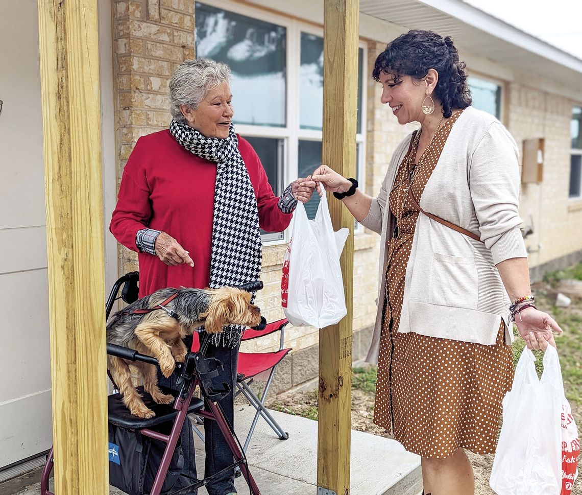 Regional Director of Philanthropy and Public Relations Lianna McNeil delivers a meal to a resident in Oak Bluff. Citizen | Trenton Whiting