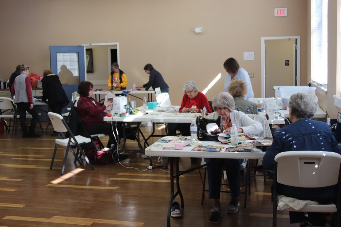 Various stations used in the charity quilt process