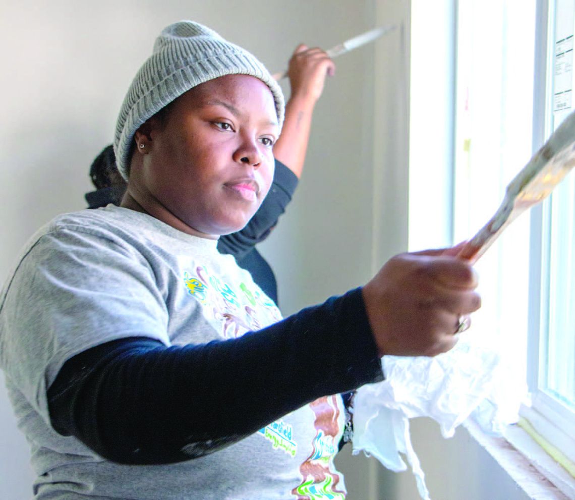 COMMUNITY CELEBRATES MLK DAY BY PAINTING HABITAT FOR HUMANITY HOME