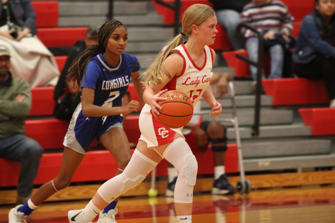 Karlee Mathis dribbling around her defender making her way to the basket. Citizen | Trent Whiting