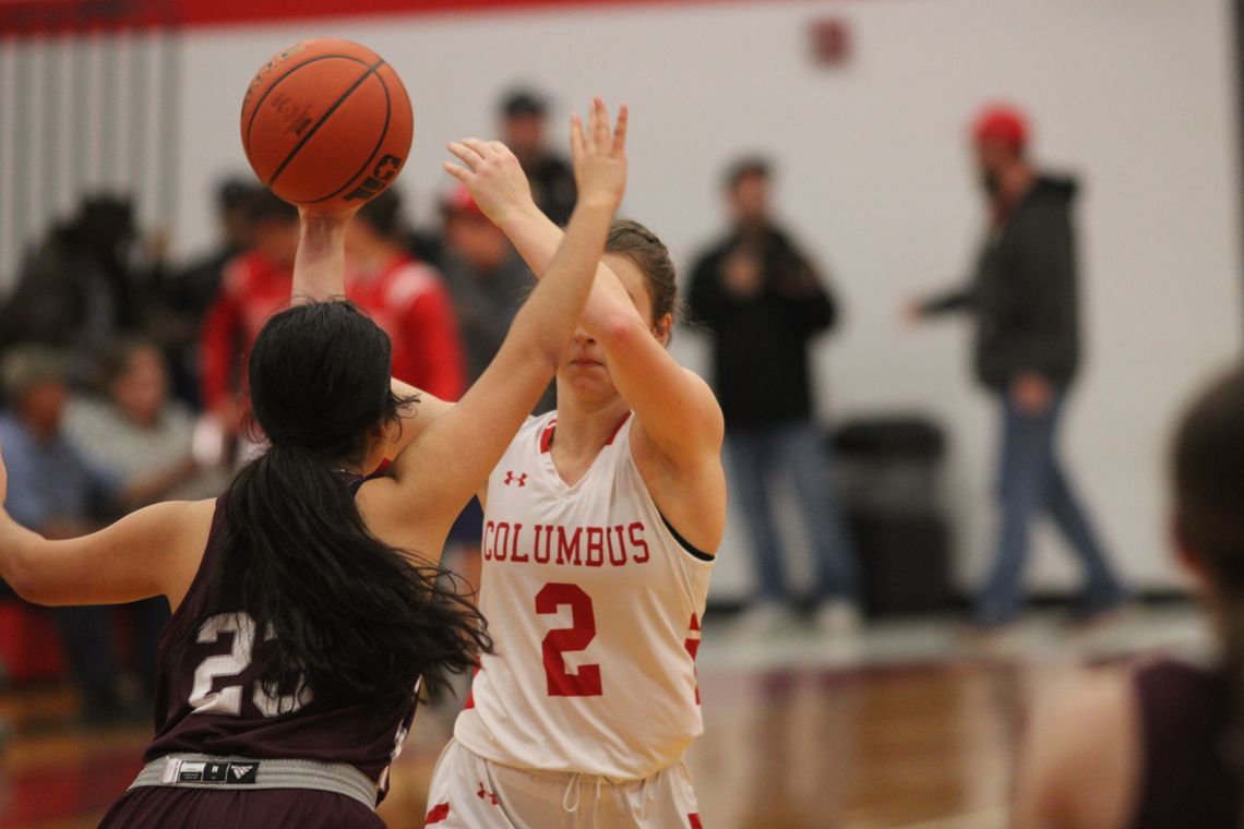 Sage Thomas passing the ball off to a teammate with a defender in her face. Citizen | Trent Whiting