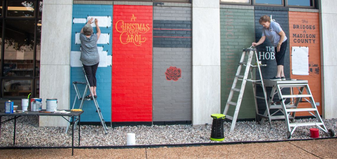 Local muralists finish book spines decorating Nesbitt