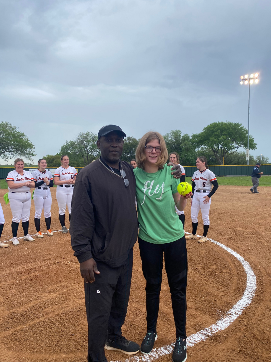 Softball team dedicates game, first pitch to Turtle Wing