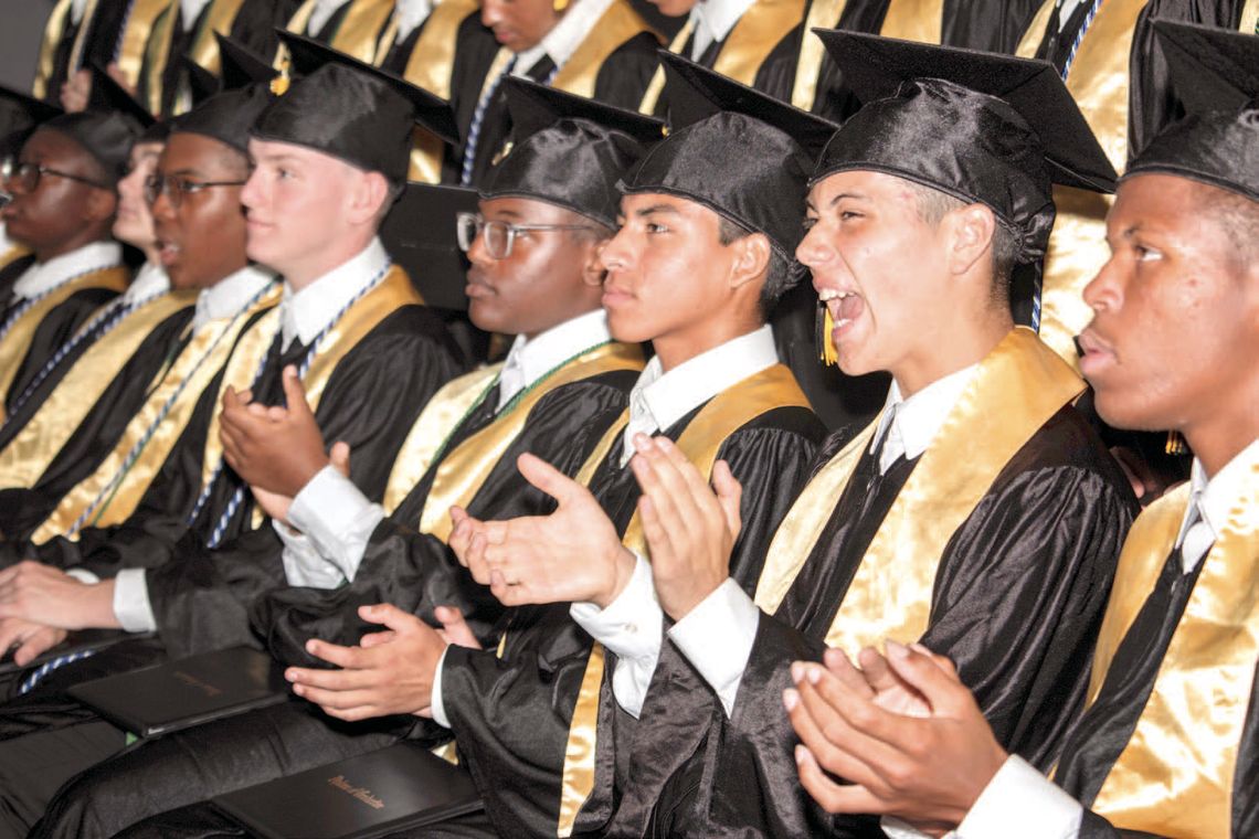 TCA graduates cross the stage in victory gold