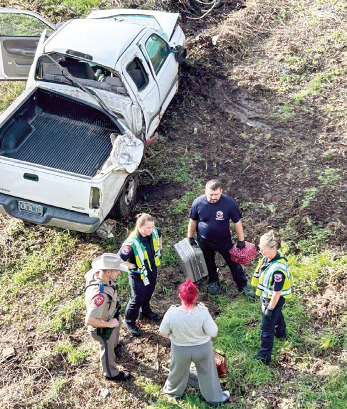 Truck leaves roadway, ends up by riverbank