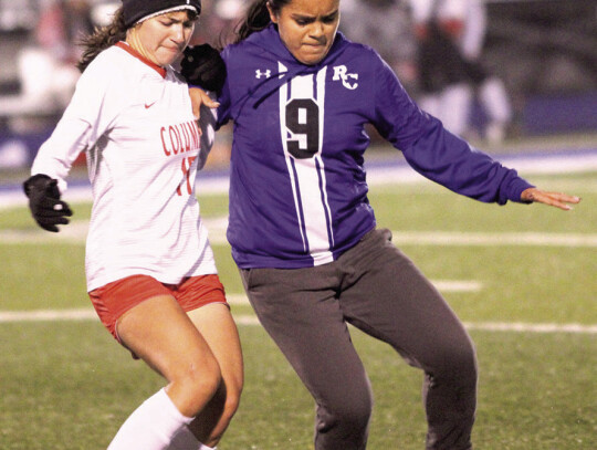 Lily Alvarez for Columbus and Melanie Gutierrez for Rice jockey for the ball.