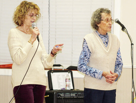 Martha Jones (left) assisting her mother, Helen Supak with door prizes.