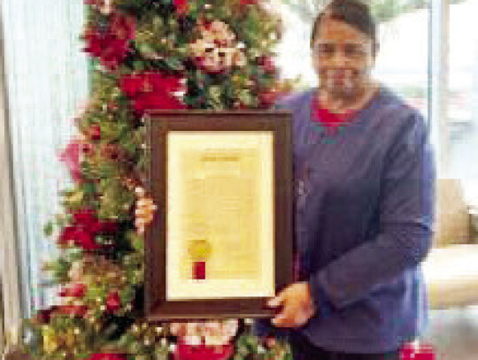 Jeno Hargrove holds a proclamation from the state Senate honoring her more than four decades of service at Columbus County Hospital. Courtesy photo