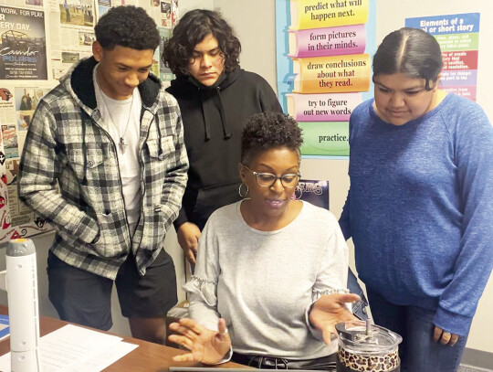 RHS journalism students from left are Jalen Porch, Victor Padilla and Marina Hernandez as they review content for their yearbook with journalism teacher Alesia Woolridge.