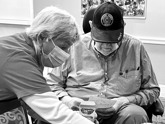 Skip Brozowski assisting a resident in decorating cards.