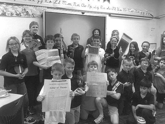 Ms. Tromblee’s fourth grade class (SAS) each holding items from the Pioneer Life Trunk. Courtesy photos