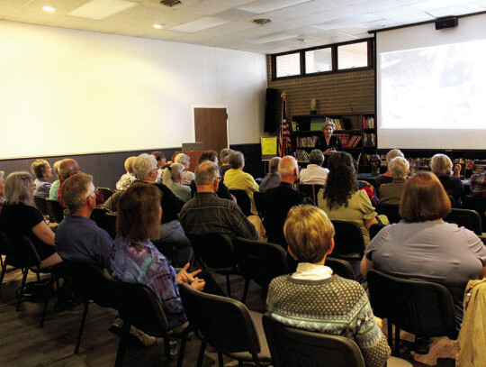 Community members listen to Amanda Danning at Nesbitt Memorial Library.