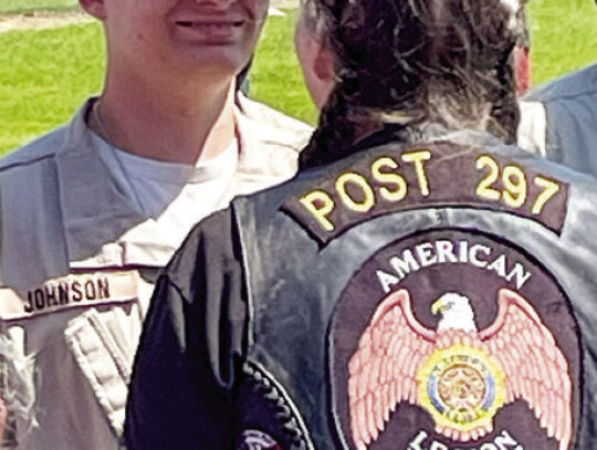 Cadet PFC Logan Johnson, a member of the Sons of the American Legion of Paul Mansir Post 297 in Benbrook, Texas and an American Legion Rider Supporter, receives his official Texas Challenge Academy Dog-Tags from American Legion Rider Rachel “Mermaid” 