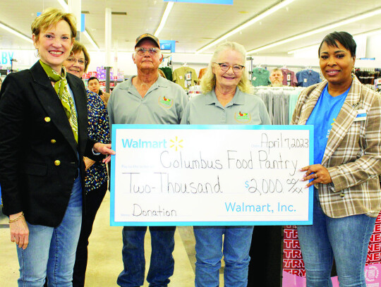 A $2,000 donation was presented to the Columbus Food Pantry: President Kelli Mitzenthin (left), Treasurer Susan Glover, Vice President Monroe Wostarek, Secretary Fausta Kaiser and Walmart Store Manager Montraie Baldwin White.