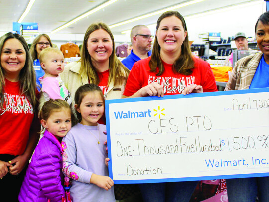 A $1,500 donation was presented to the Columbus Elementary School PTO: Arlynne Blymyer (left), Monica Heffley and daughters Sophie Heffley (infant), Natalie Heffley and Blair Heffley, Mandi Kulhanek and Walmart Store Manager Montraie Baldwin White.