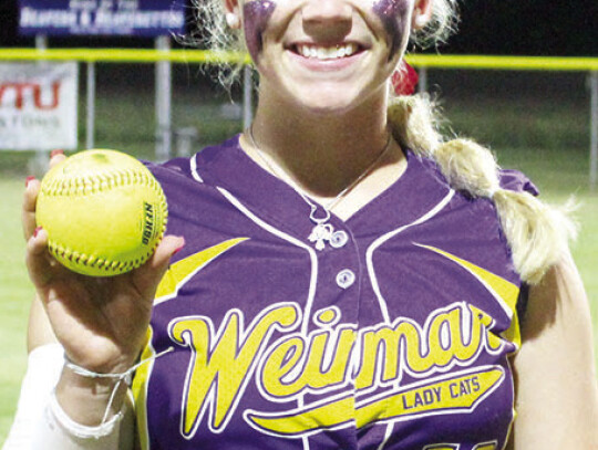 Junior Hannah Fisbeck poses with her homerun ball.