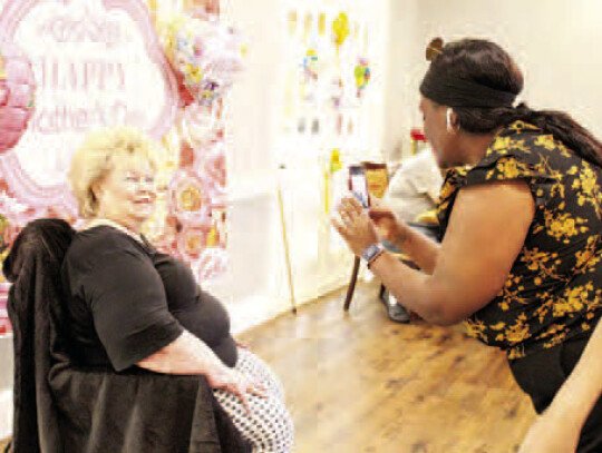 Columbus Oaks Assisted Living Activity Director LaBrittany Miller taking a glamour shot of a resident.