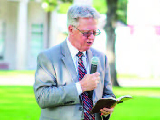 Pastor Victor Morrison reading a scripture for the invocation.