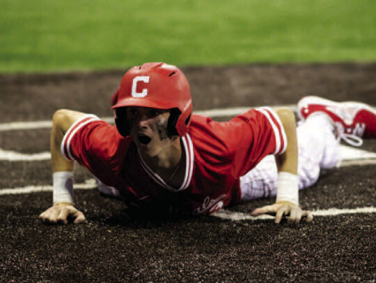 Trevor Berger slides home the game-winning run in game one.
