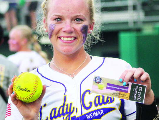 Hannah Fisbeck with her winning homerun ball and a ticket to state. Citizen | Colleen Garcia