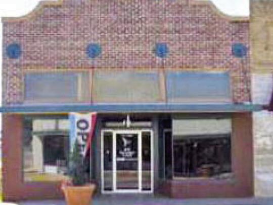 Damon Building, located at 221 E. Main Street, was built in 1925 when the old “Blue Store” from the 1860s was demolished as a landmark to usher in a new era of modern business on Main Street. The one-story dark red brick building features a Mission-st