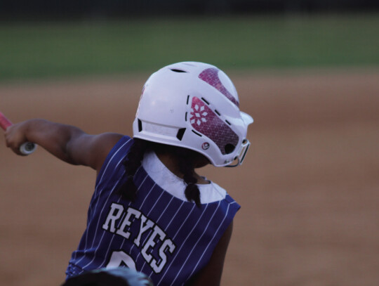 Lucy Reyes takes a big cut at a machine pitch against Weimar.