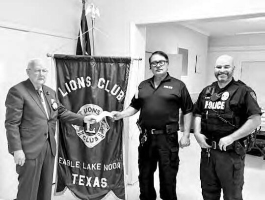 Eagle Lake Noon Lions Club President Stan Warfield presents Eagle Lake Police Department Sgt. Benny Arriola and Officer Patric Gonzales a donation to be added to the equipment fund.