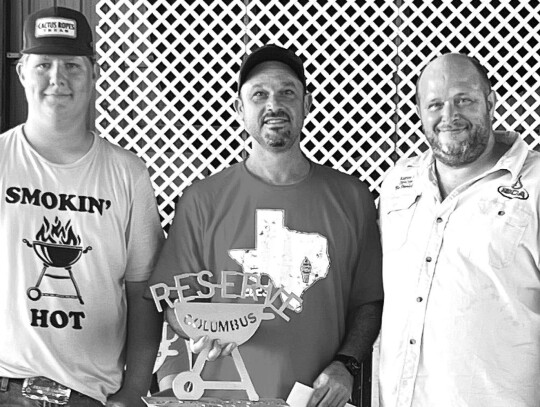 Reserve Champion, from left: Logan Mazac, Michael Triola, head cook of All Ways Smoking, and Bo Daniel, judge in training/ announcer.