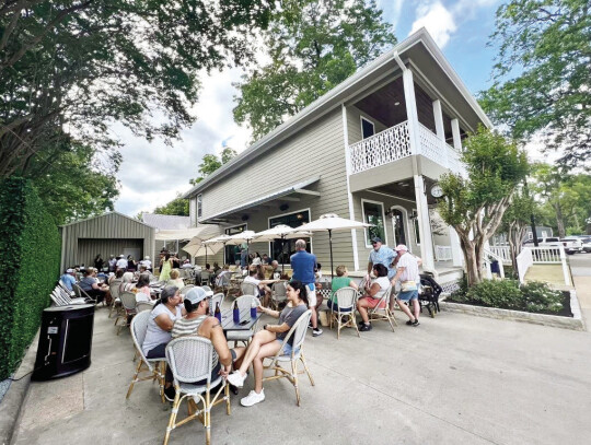 Guests enjoying beverages outside the Magnolia Society during the Magnolia Days Festival weekend. Courtesy | Magnolia Society