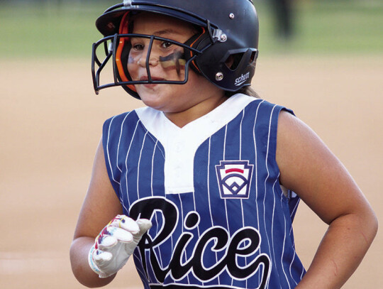 Nhyla Cardenas jogs back to the dugout after scoring a run.