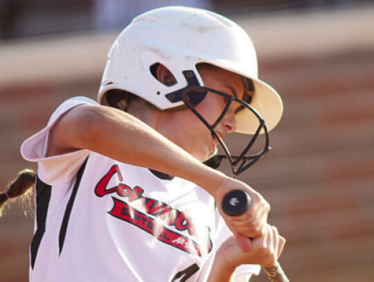 Lila Berger takes a practice swing before receiving her pitches at the plate.