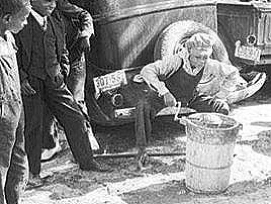 Boys churning ice cream for a summer’s delight.