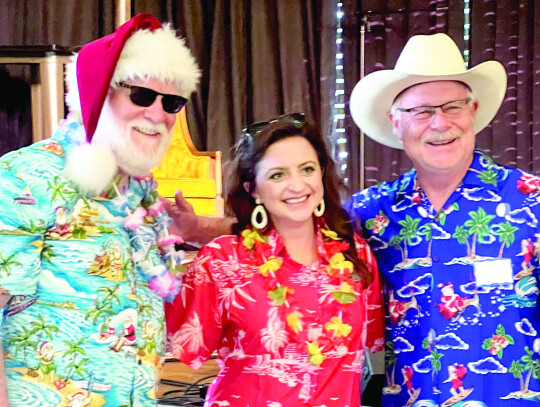 Pictured from left to right are the event’s Santa Claus, Paige Sciba and the adult contest winner, Steve McCullough.