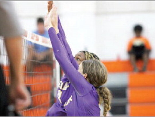 Chandley Tolbert and Janiyah Cooper go for the block at the net.