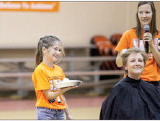 Maddie Wright was the lucky student chosen to pie Mrs. Bartels at the pep rally. Randi Glueck in the background led the festivities.