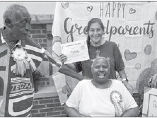 Bobbie Jo Contreras holds the adoption certificate for two seniors at the event. Courtesy photos