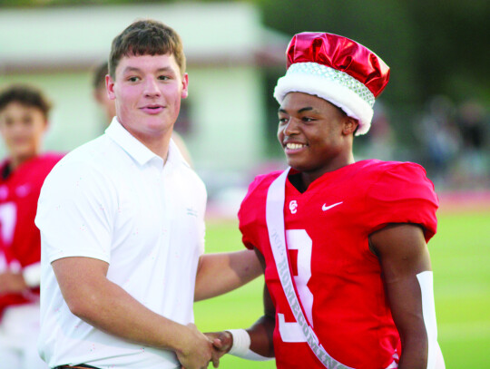 Last year’s homecoming king Conner Geisler passes on the honor to Ty’Vone Whitehead.