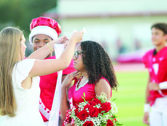 Last year’s homecoming queen Mayson Post passes on the honor to Jayda Ramirez.