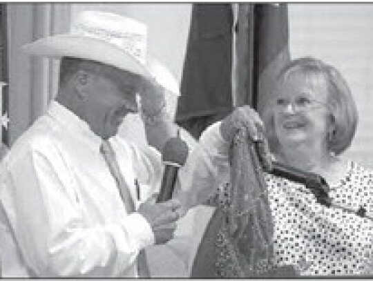 Todd Krenek prepares to lead the auction following Vicki Powers announcing the silent auction winners. Citizen | Trenton Whiting