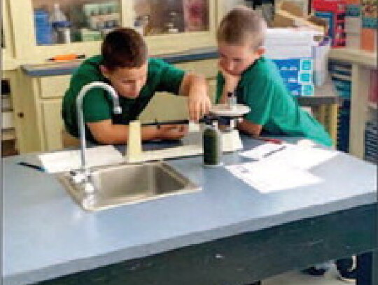 Fifth graders Eli Blasig (left) and Cade Wessels work together during a science lab at St. Michael Catholic School in Weimar. Their science teacher is Courtney Weid (not pictured).