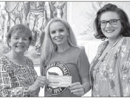 The Live Oak Art Center Kids Program received a check from the CCWO. Pictured from is Estelle Mostyn, Tori Kramr on the LOAC board, and Carley Howlett the LOAC executive director.