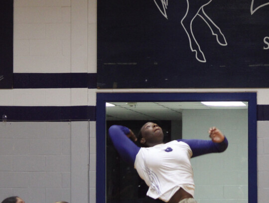 Senior outside hitter Tricelle Fields jumping up to slam the ball down and earn her team a point.