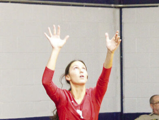 Left: Lady Cardinals’ senior Middle Blocker Ember Mandola serving the ball during their match against Rice Tuesday night. Right: Sophomore outside hitters Breelyn Freeman and Kimberly Hernandes diving for a serve to bump the ball to their setter.